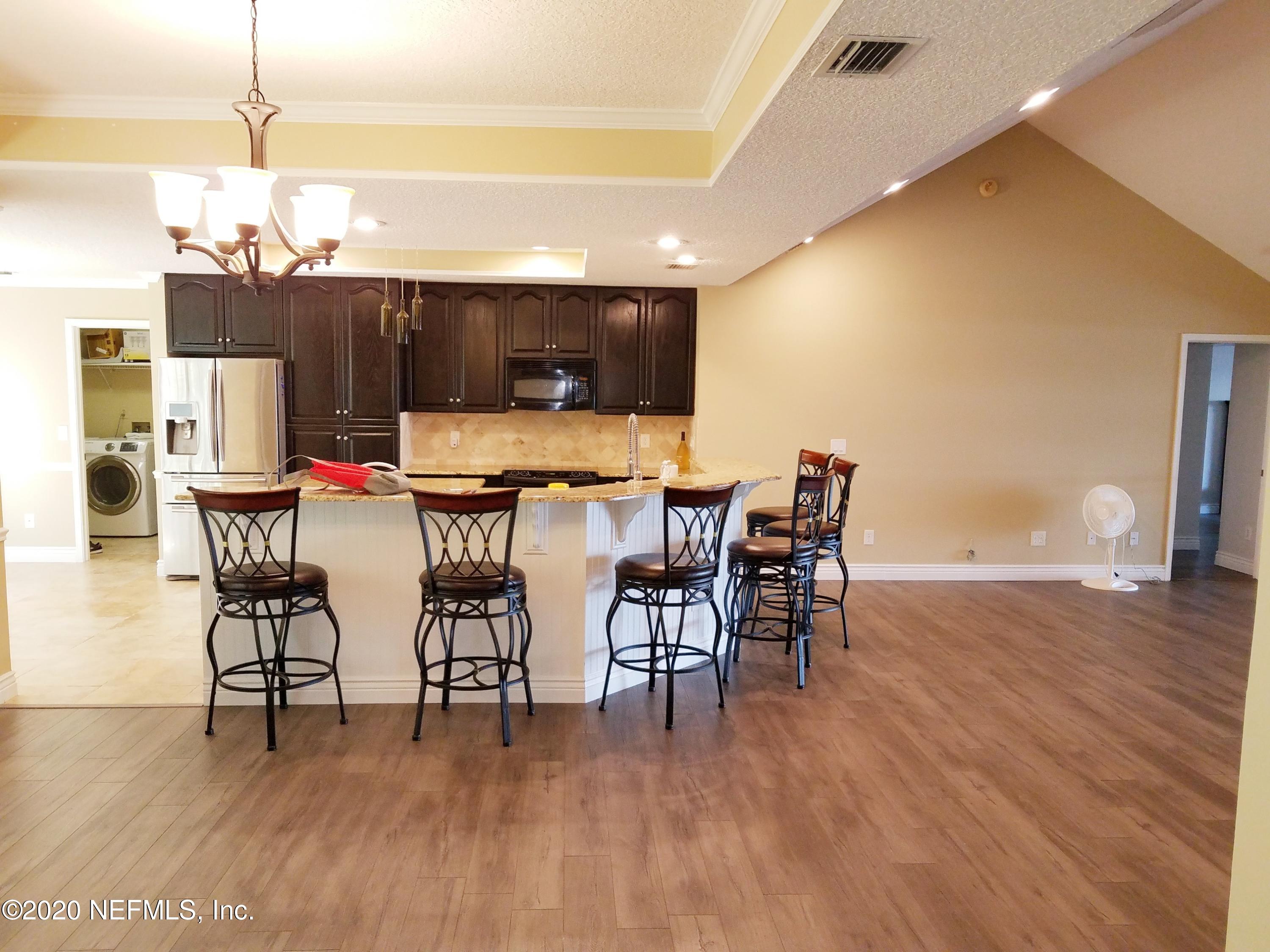 1501 Cedar Bay Road Jacksonville, FL 32218 - Photo 18 of 49 a dining room with furniture and wooden floor