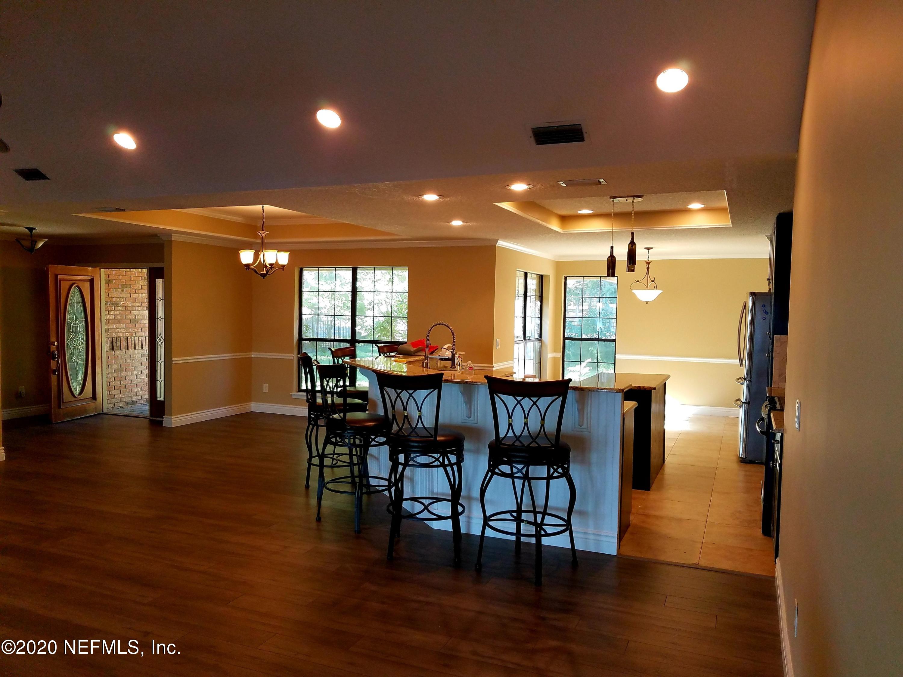 1501 Cedar Bay Road Jacksonville, FL 32218 - Photo 23 of 49 a view of a dining room with furniture and wooden floor