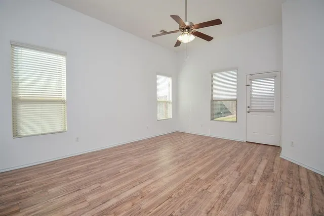wooden floor in an empty room with a window