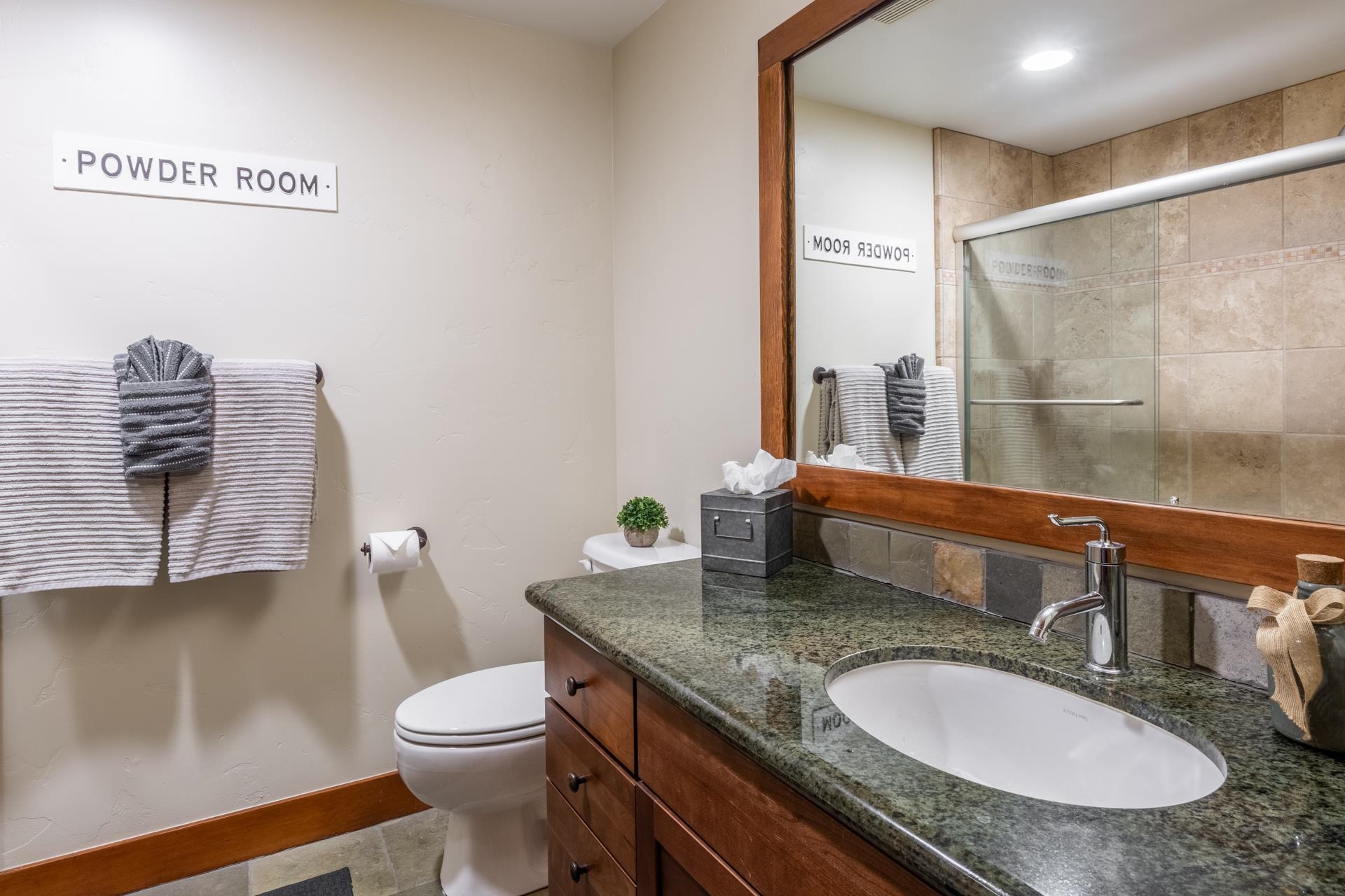 125 Davison Road, Unit 1 Mammoth Lakes, CA 93546 - Photo 34 of 46 a bathroom with a granite countertop sink a toilet and a mirror