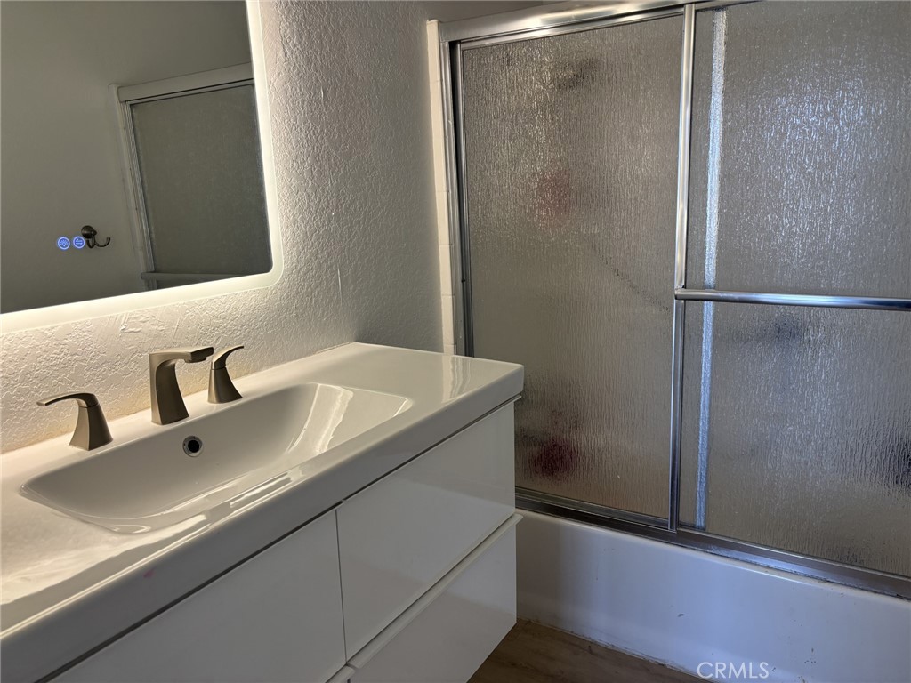 9591 Colfax Road Phelan, CA 92371 - Photo 11 of 24 a bathroom with a sink and mirror