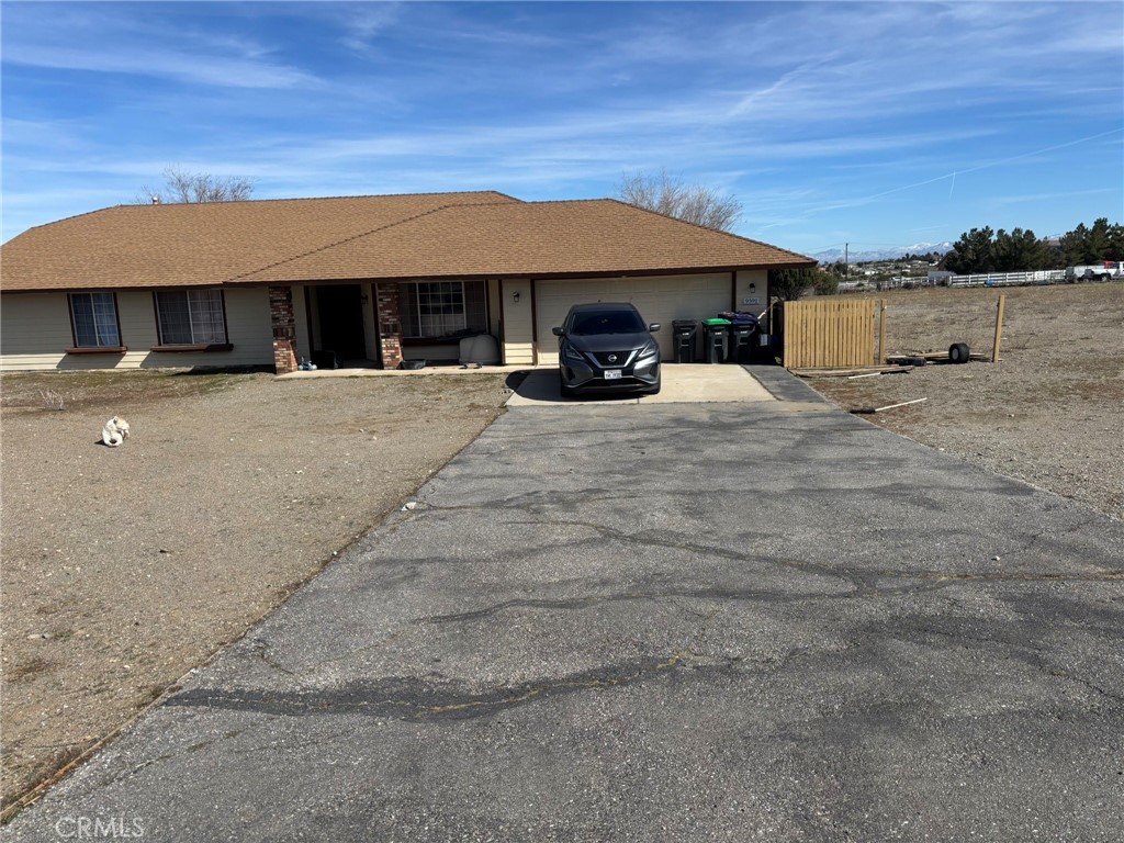 9591 Colfax Road Phelan, CA 92371 - Photo 23 of 24 a view of a house with a yard and sitting area