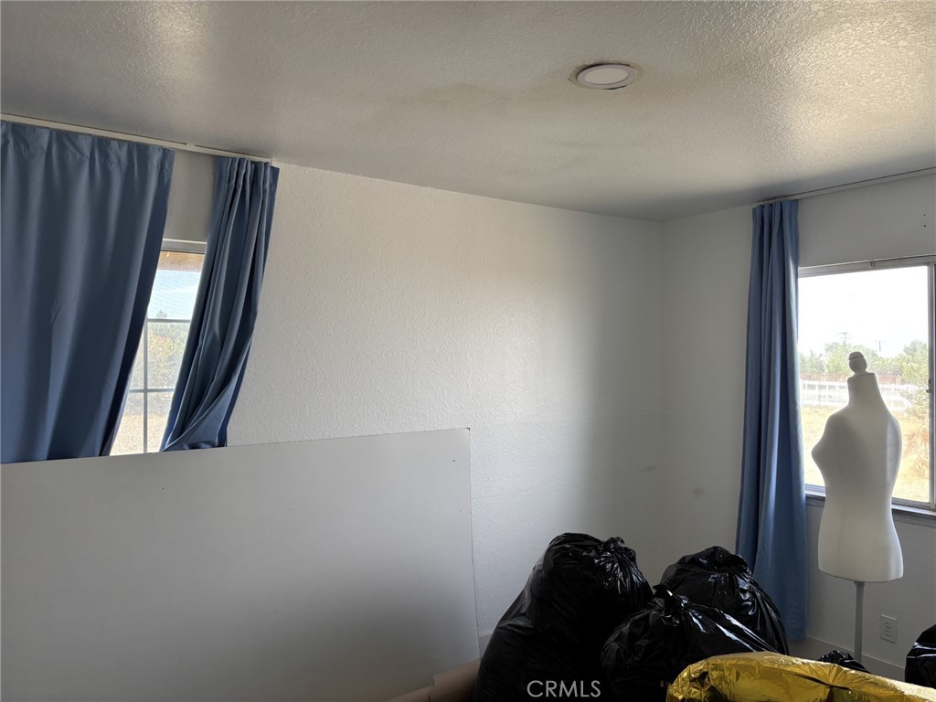 9591 Colfax Road Phelan, CA 92371 - Photo 6 of 24 a view of hallway with furniture and a window