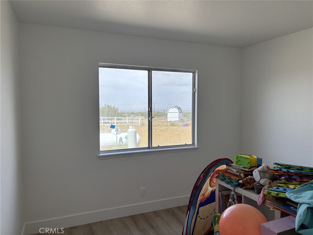 9591 Colfax Road Phelan, CA 92371 - Photo 7 of 24 a view of a room that has a bed and a window