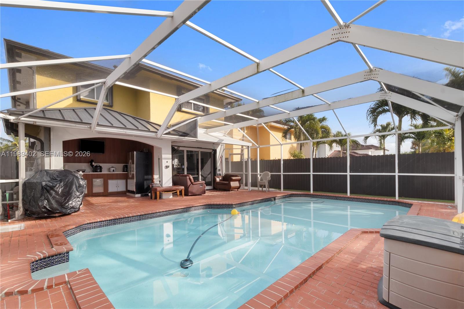 14052 Southwest 167th Terrace Miami, FL 33177 - Photo 14 of 33 a view of a swimming pool with a patio
