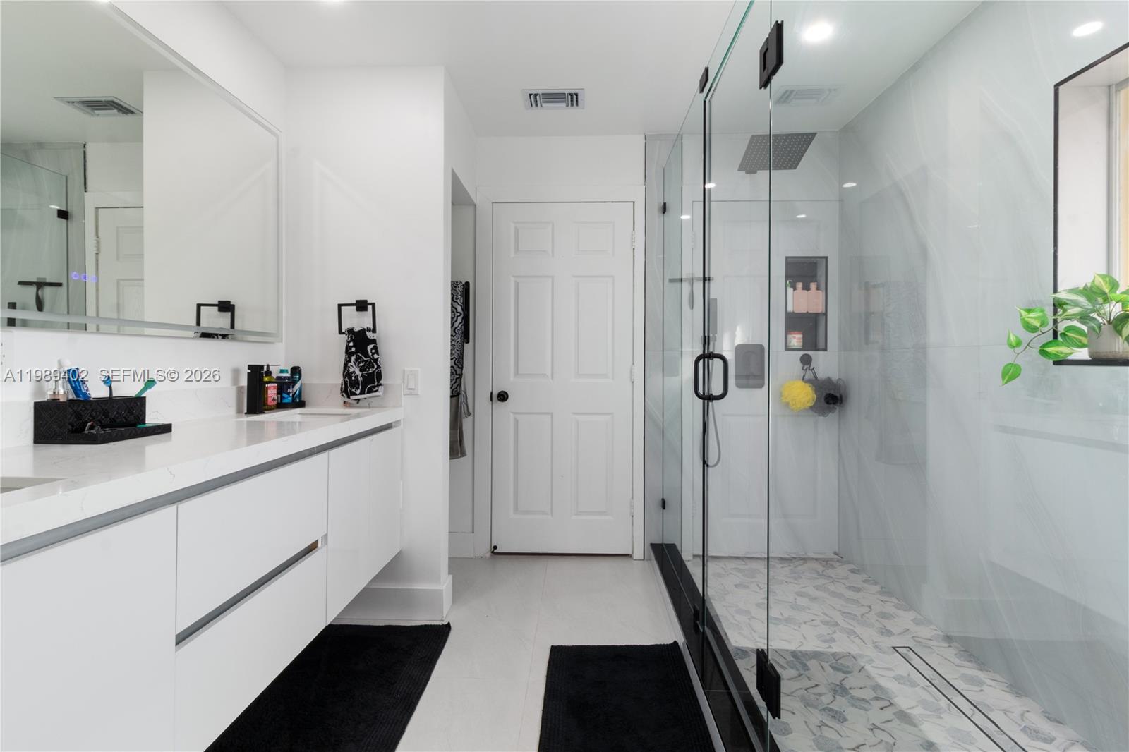 14052 Southwest 167th Terrace Miami, FL 33177 - Photo 20 of 33 a bathroom with a double vanity sink and shower