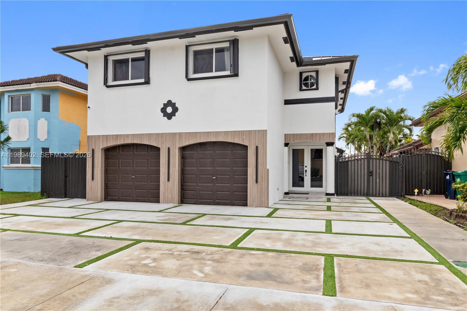 14052 Southwest 167th Terrace Miami, FL 33177 - Photo 2 of 33 a front view of a house with glass windows and yard