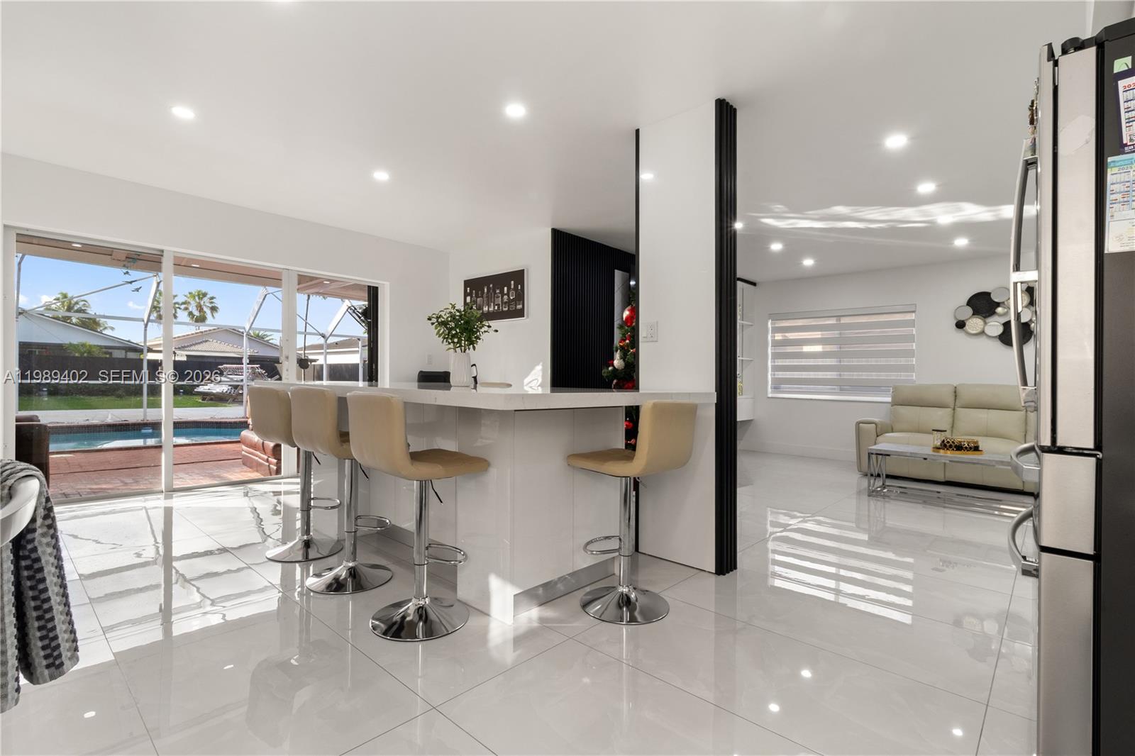14052 Southwest 167th Terrace Miami, FL 33177 - Photo 8 of 33 a room with a table chairs and mirrors