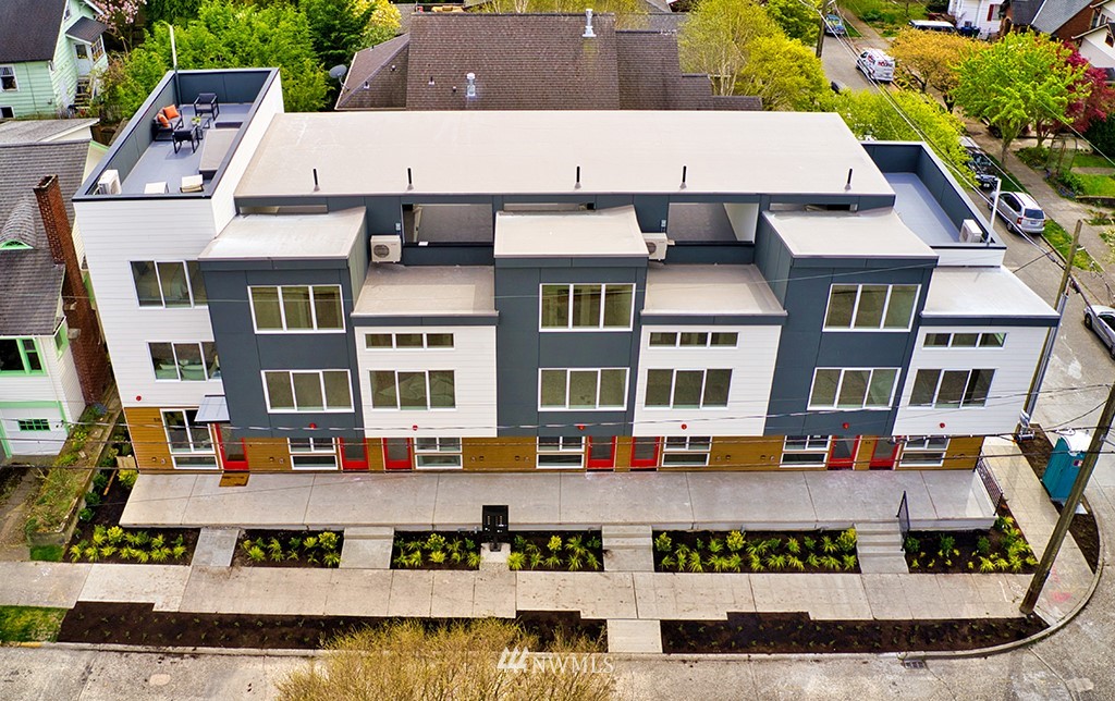 an aerial view of residential houses with outdoor space