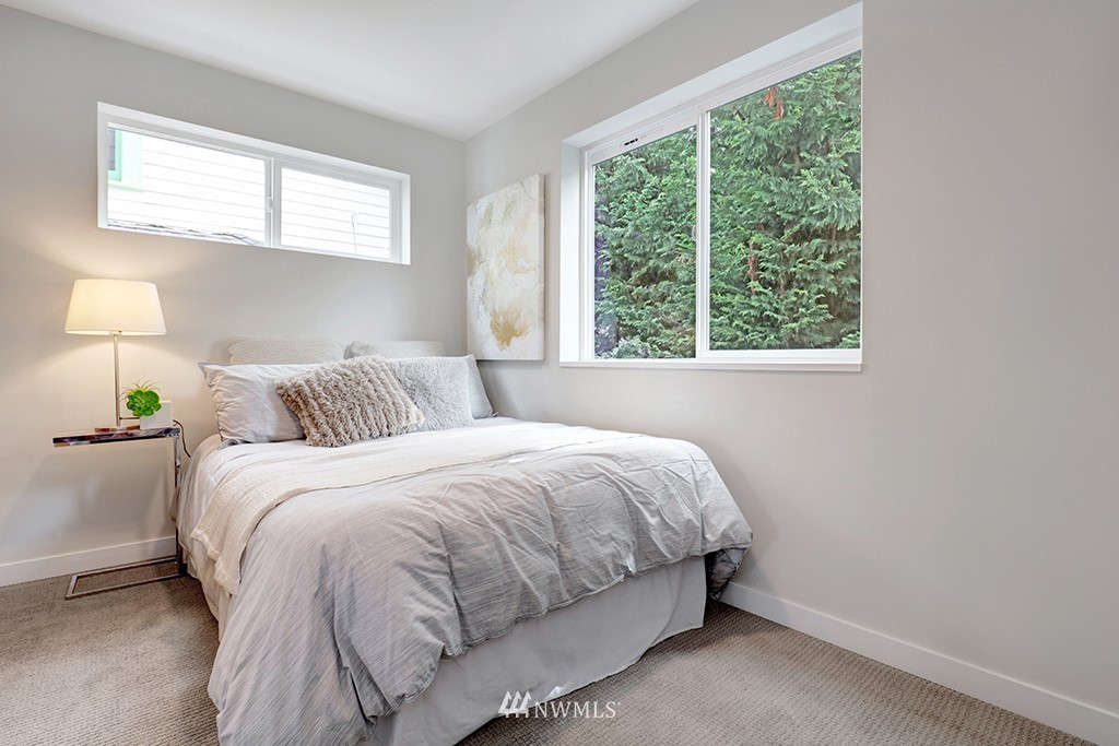 515 Northwest 70th Street Seattle, WA 98117 - Photo 15 of 32 a bedroom with a bed and a window