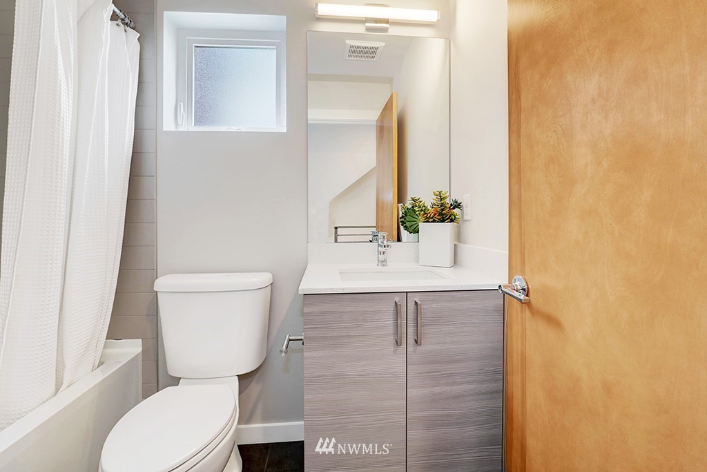 515 Northwest 70th Street Seattle, WA 98117 - Photo 16 of 32 a bathroom with a sink a toilet and shower
