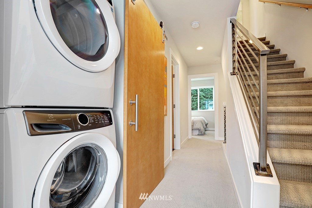 515 Northwest 70th Street Seattle, WA 98117 - Photo 17 of 32 a view of a bedroom with washer and dryer