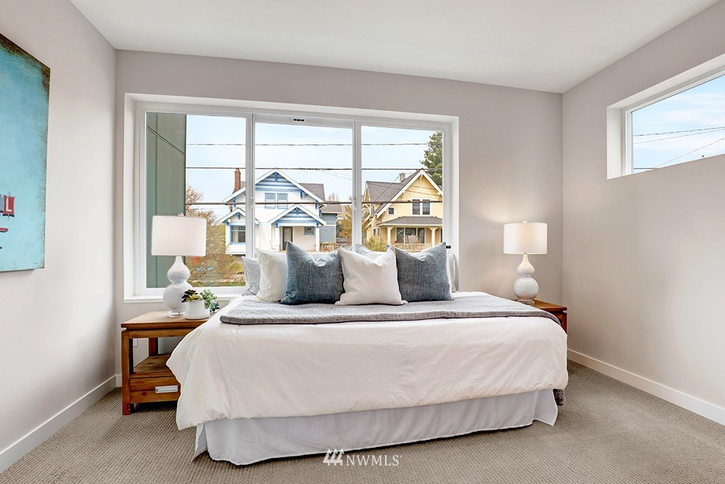 515 Northwest 70th Street Seattle, WA 98117 - Photo 18 of 32 a large white bed sitting in a room next to a window