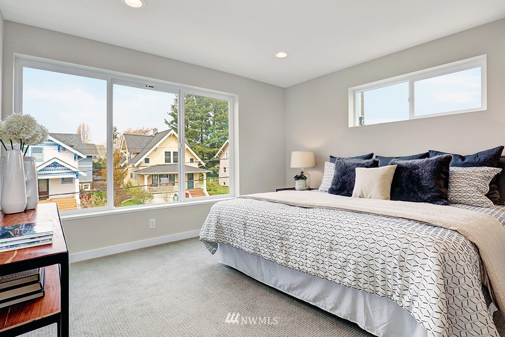 515 Northwest 70th Street Seattle, WA 98117 - Photo 22 of 32 a bedroom with a bed and a window