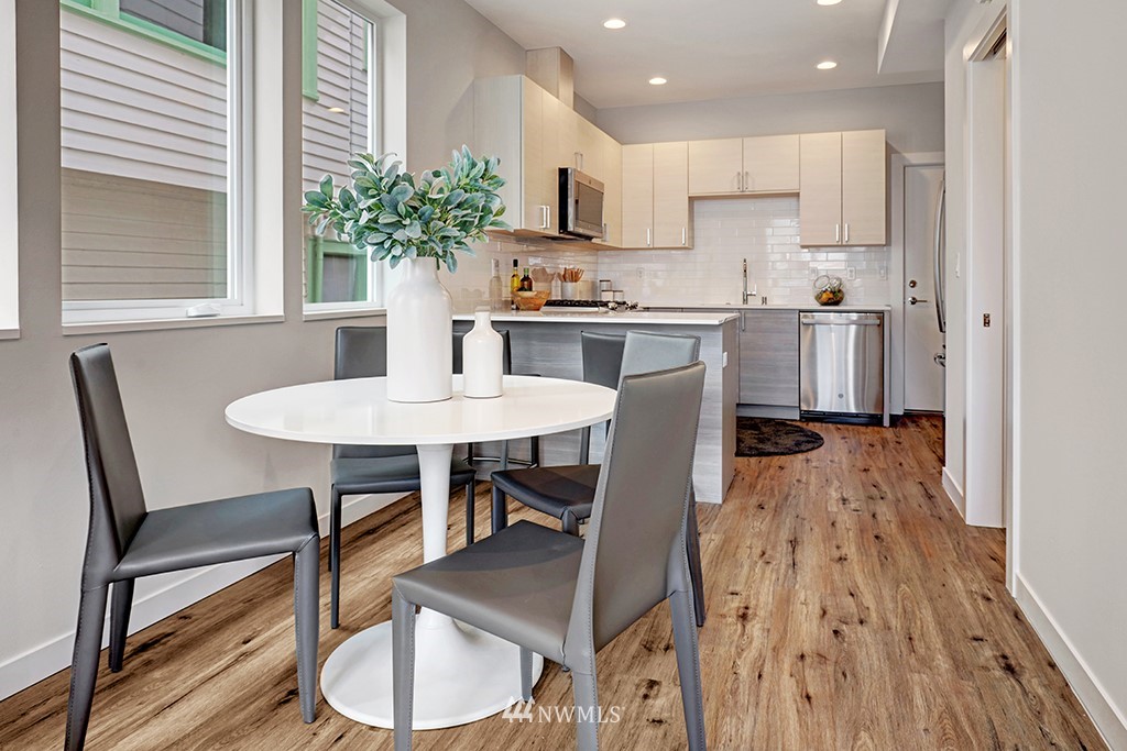 515 Northwest 70th Street Seattle, WA 98117 - Photo 8 of 32 a kitchen with a table and chairs in it
