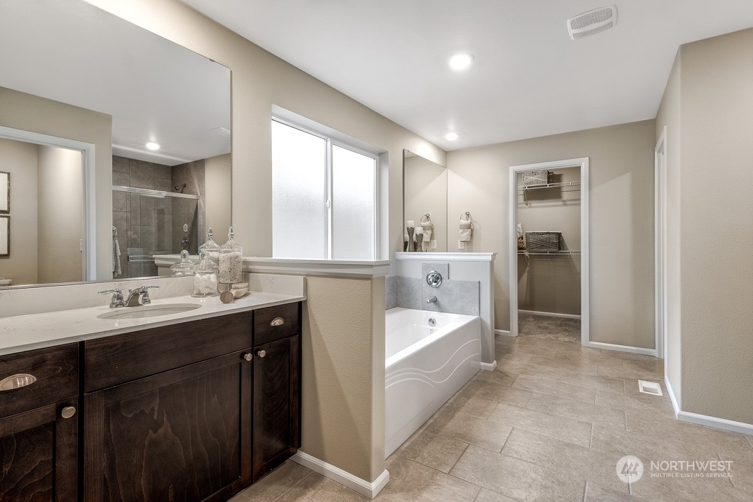 1606 12th Place, Unit 1161 Sultan, WA 98294 - Photo 13 of 20 a en suite bathroom with a tub sink shower and mirror