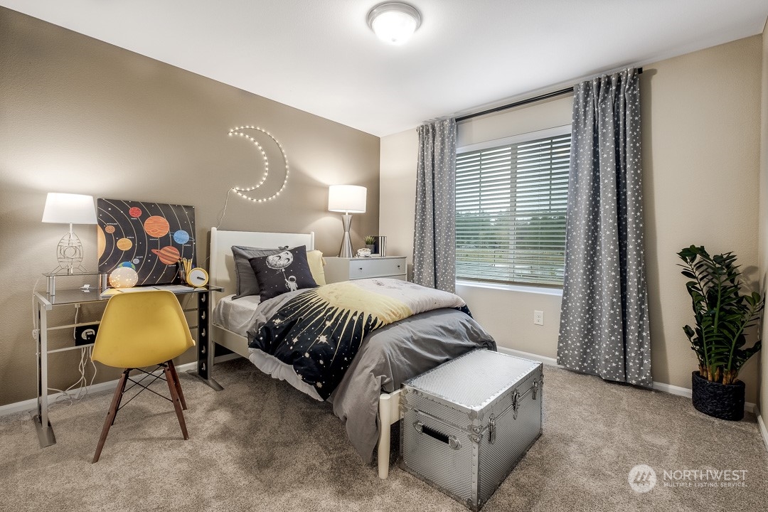 1606 12th Place, Unit 1161 Sultan, WA 98294 - Photo 16 of 20 a bedroom with a bed and a potted plant next to a window