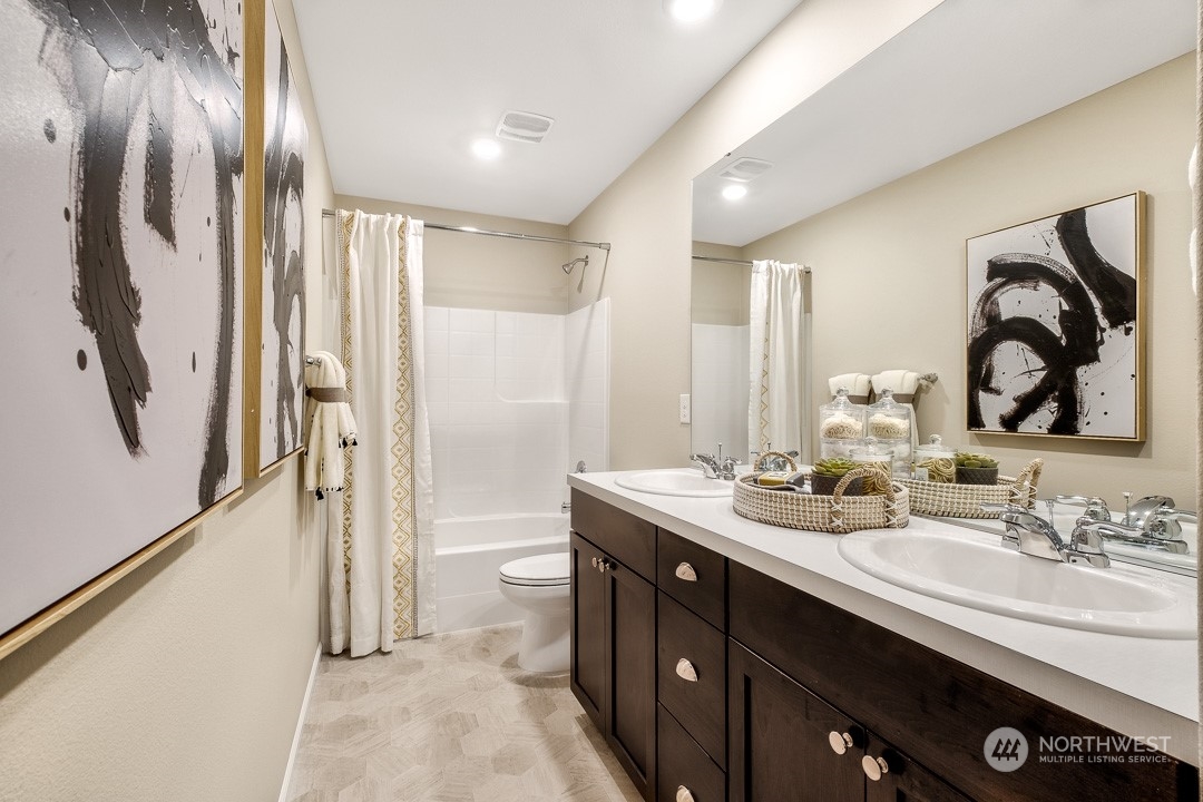 1606 12th Place, Unit 1161 Sultan, WA 98294 - Photo 17 of 20 a spacious bathroom with a double vanity sink and a mirror