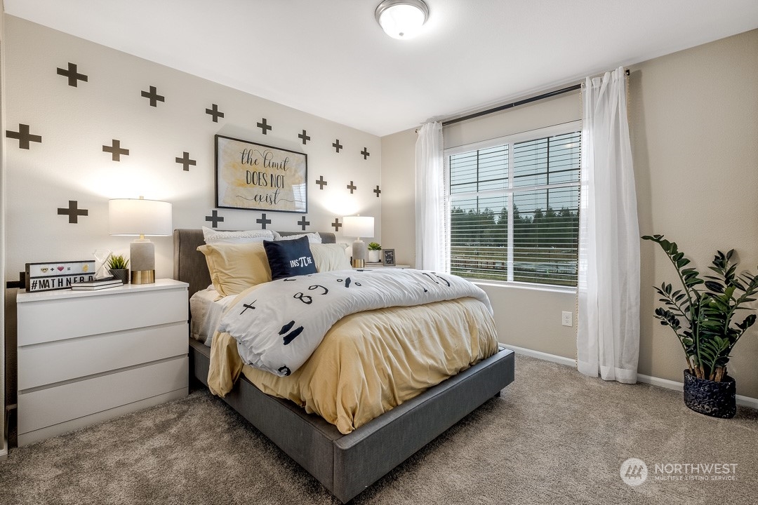 1606 12th Place, Unit 1161 Sultan, WA 98294 - Photo 18 of 20 a bed sitting in a bedroom next to a window and potted plant