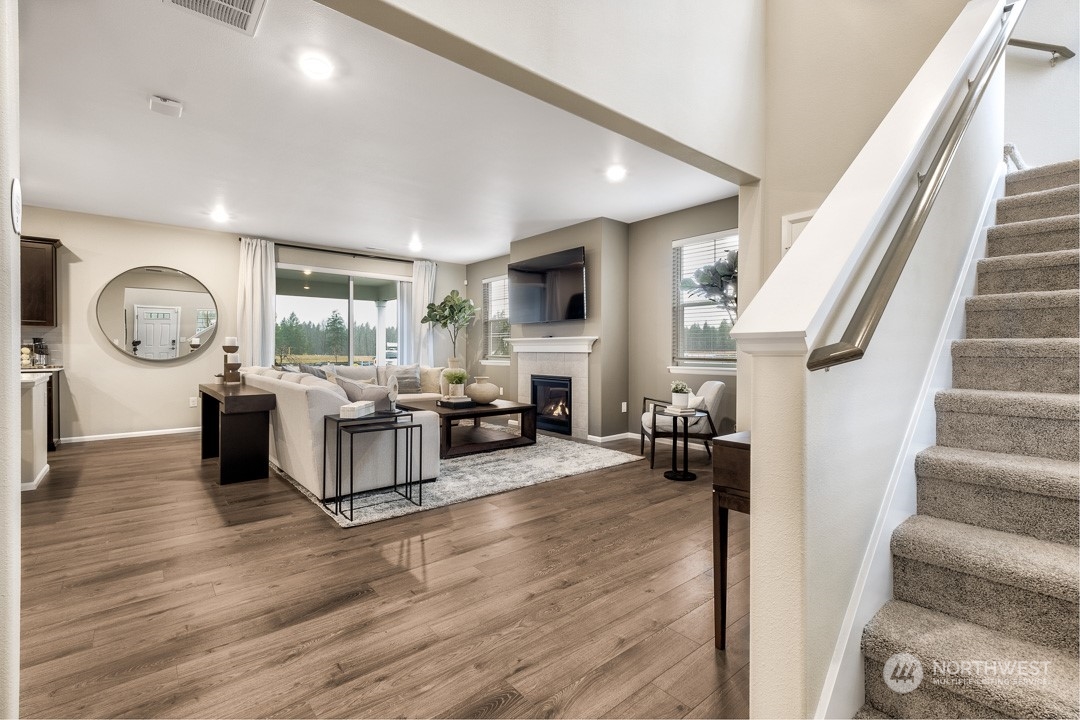 1606 12th Place, Unit 1161 Sultan, WA 98294 - Photo 5 of 20 a living room with fireplace furniture and a wooden floor