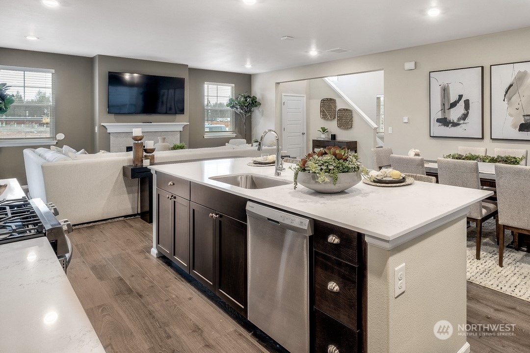 1606 12th Place, Unit 1161 Sultan, WA 98294 - Photo 10 of 20 a kitchen with a stove and a flat screen tv