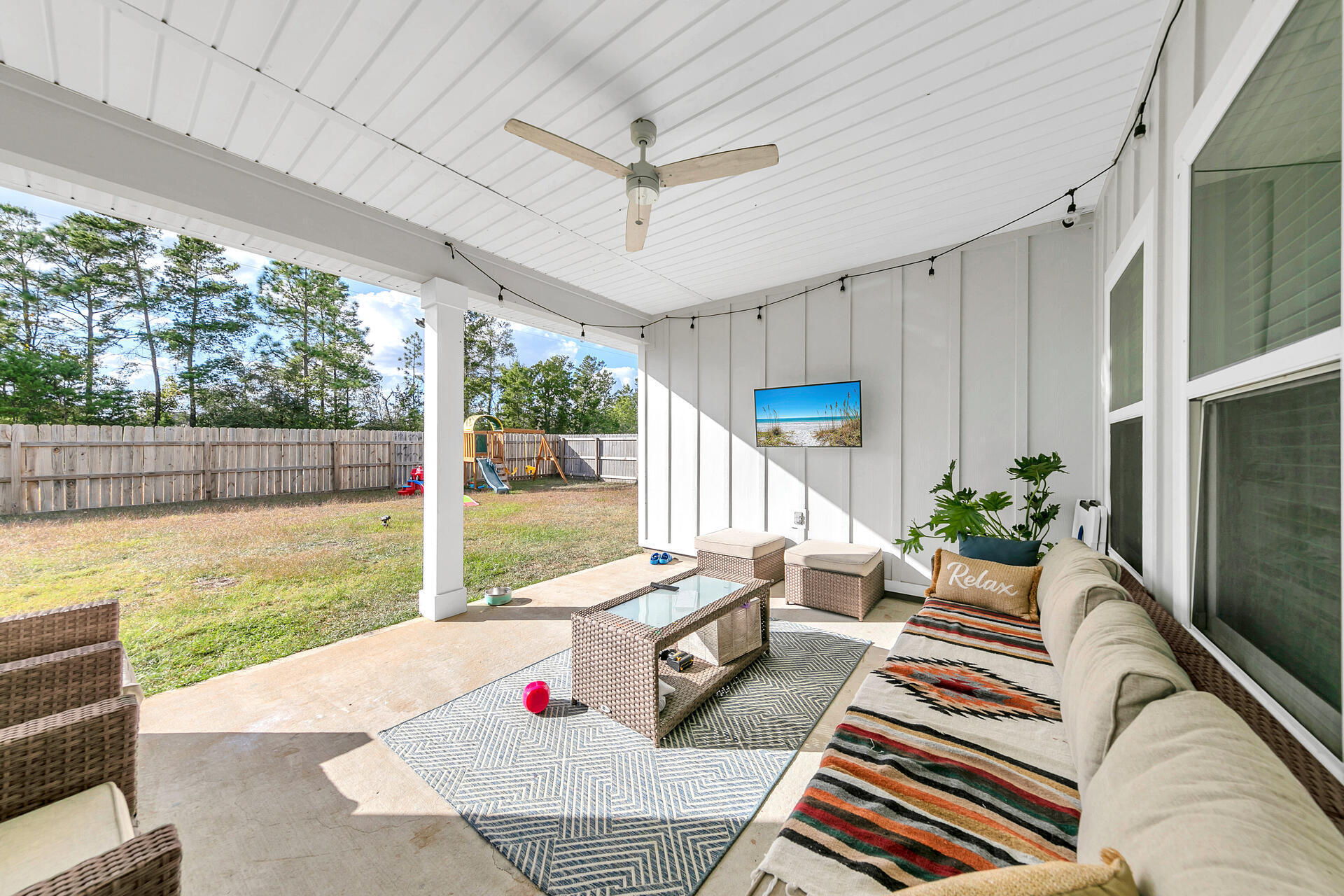 720 Quintana Street Crestview, FL 32539 - Photo 21 of 26 a living room with patio furniture and a floor to ceiling window