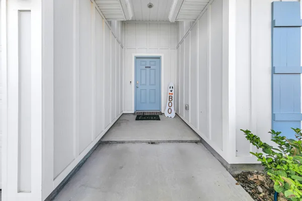 a view of a hallway with potted plants