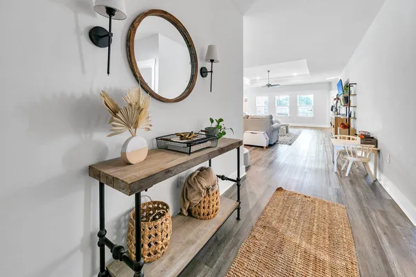 a living room with furniture and a wooden floor