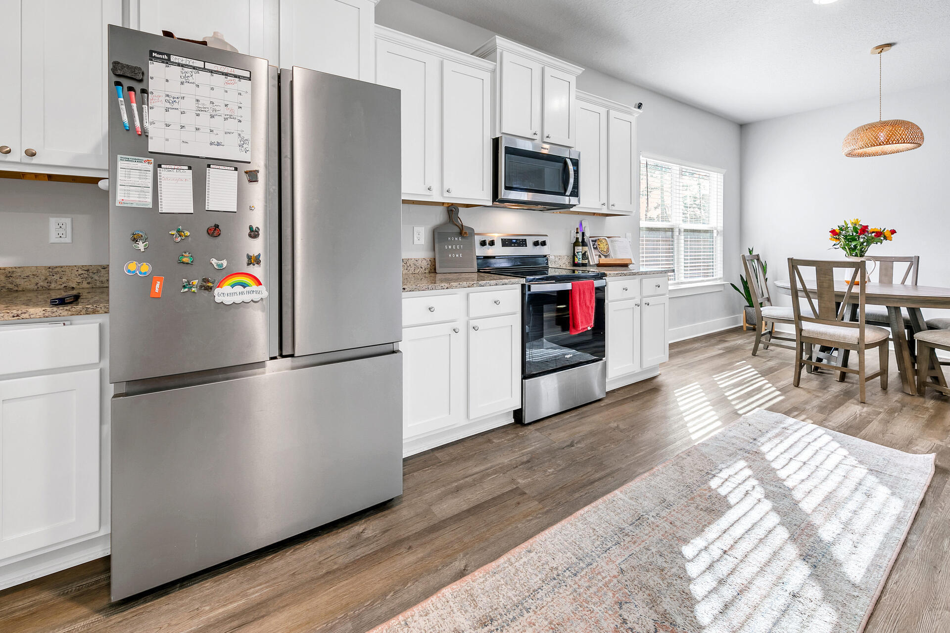720 Quintana Street Crestview, FL 32539 - Photo 9 of 26 a kitchen with stainless steel appliances a refrigerator stove microwave and a dining table