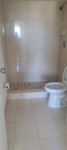 a bathroom with a toilet and a shower