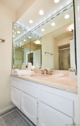a white toilet next to a bathroom