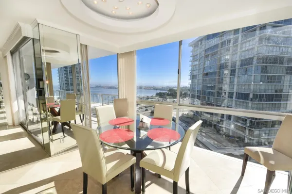 a dining room with furniture and a floor to ceiling window