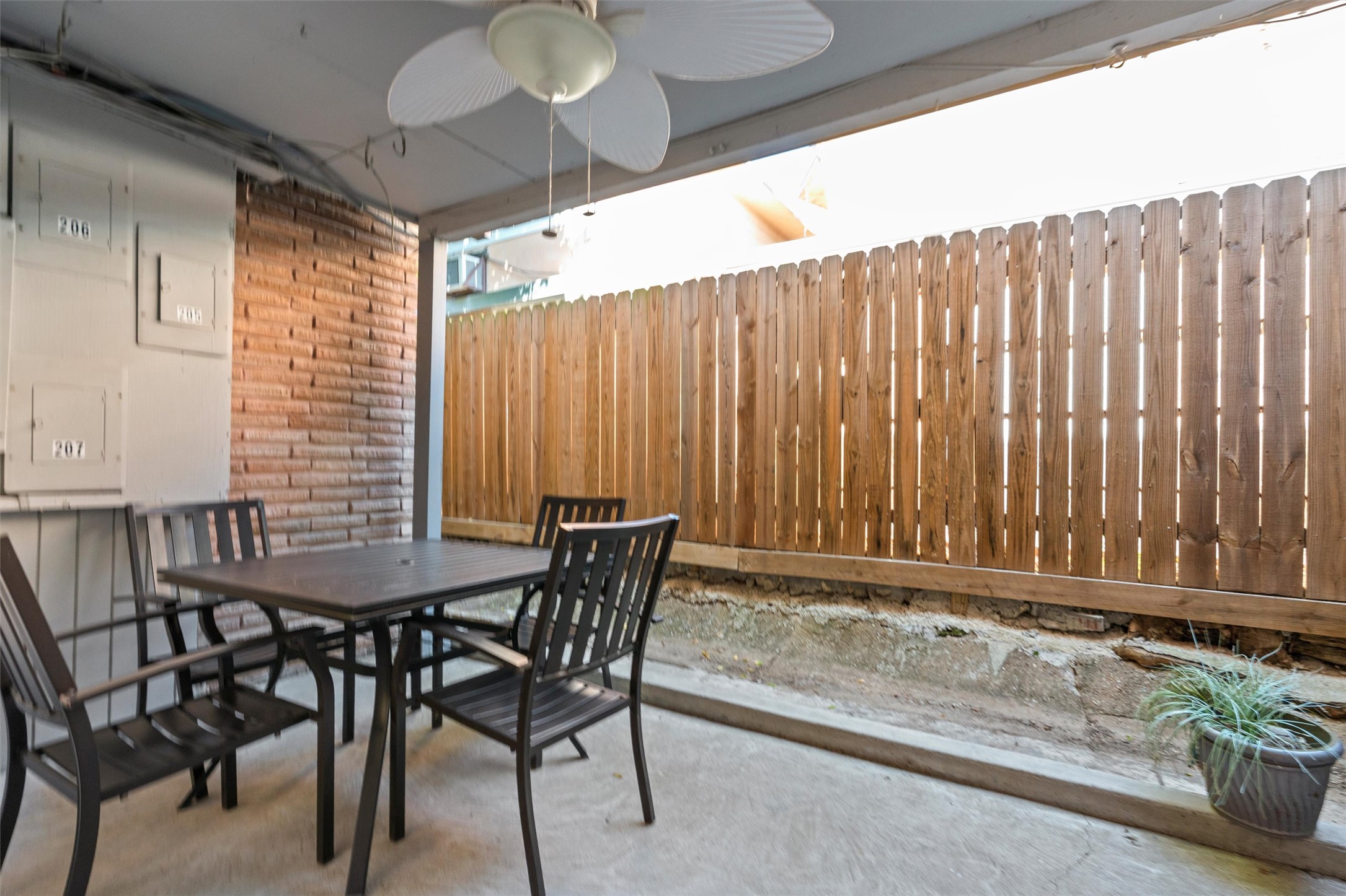 2208 Enfield Road, Unit 10500 Austin, TX 78703 - Photo 20 of 34 Covered patio space featuring a ceiling fan with light fixture and concrete flooring