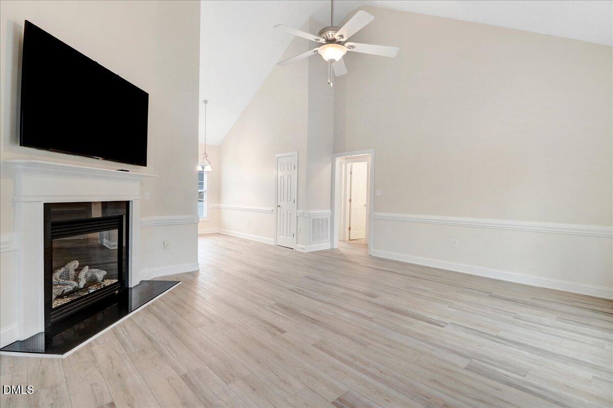 4416 Sunflower Court Wilson, NC 27896 - Photo 16 of 39 a view of an empty room with wooden floor and a fireplace