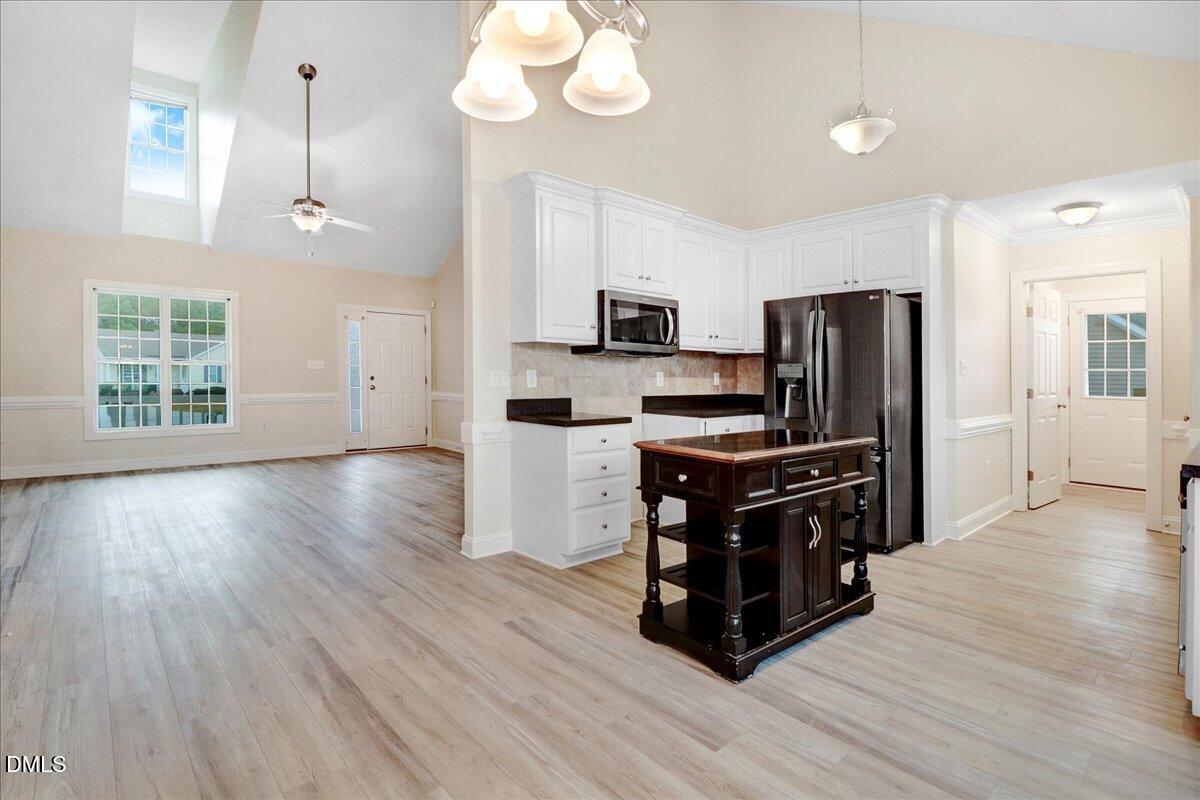 4416 Sunflower Court Wilson, NC 27896 - Photo 20 of 39 a kitchen with wooden floors appliances and cabinets