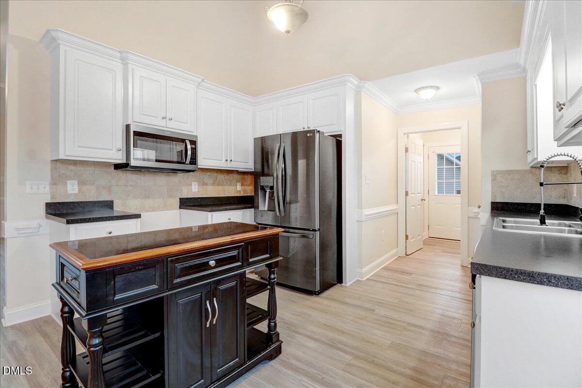 4416 Sunflower Court Wilson, NC 27896 - Photo 21 of 39 a kitchen with stainless steel appliances a stove microwave and a refrigerator