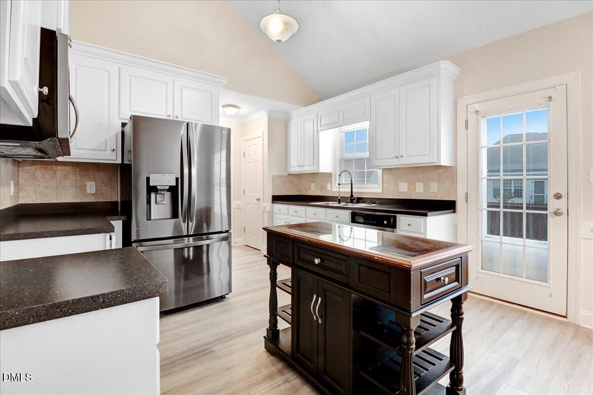 4416 Sunflower Court Wilson, NC 27896 - Photo 23 of 39 a kitchen with kitchen island a counter appliances a sink and cabinets