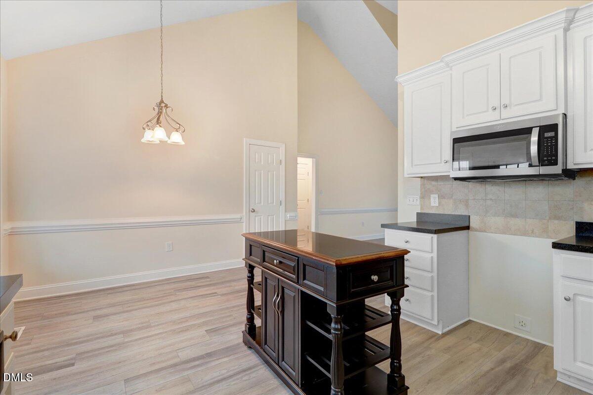 4416 Sunflower Court Wilson, NC 27896 - Photo 25 of 39 a kitchen with stainless steel appliances a stove a refrigerator and a microwave