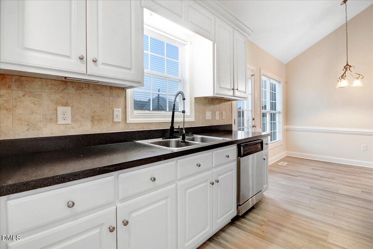 4416 Sunflower Court Wilson, NC 27896 - Photo 26 of 39 a kitchen with granite countertop white cabinets and a sink