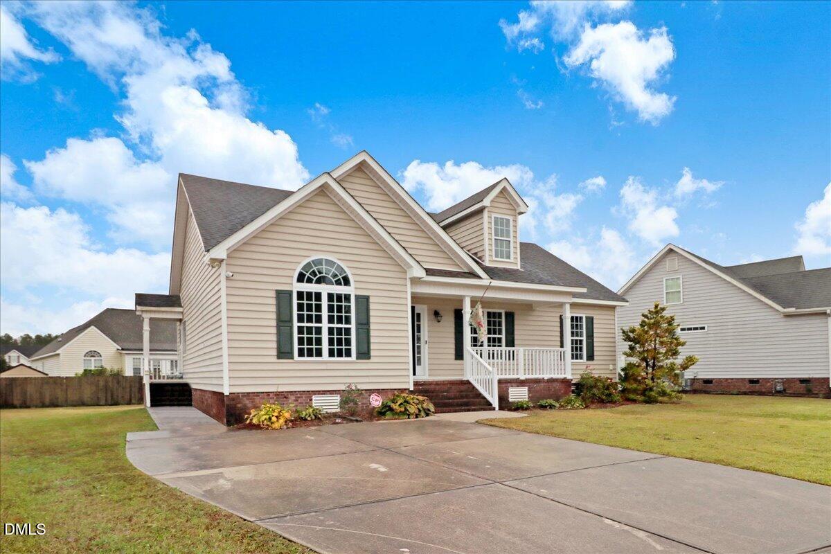 4416 Sunflower Court Wilson, NC 27896 - Photo 2 of 39 a front view of a house with a garden and yard