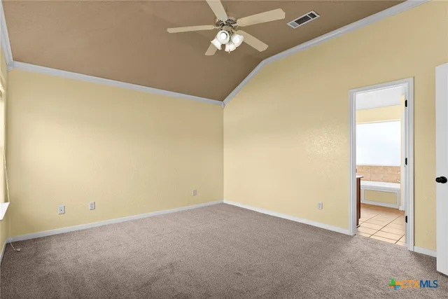 an empty room with a ceiling fan and a window