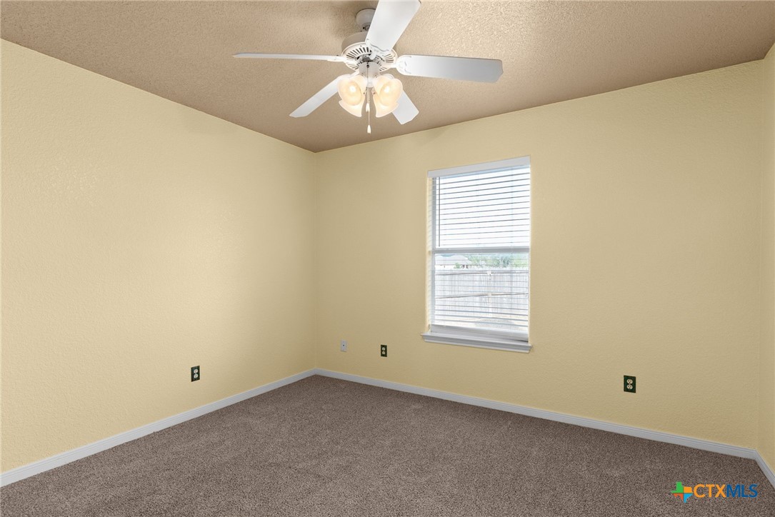 5705 Bald Ridge Court Killeen, TX 76542 - Photo 22 of 28 an empty room with a window and a ceiling fan
