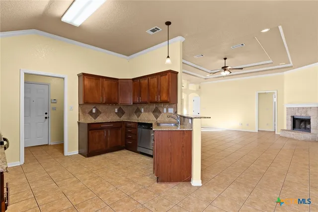 a kitchen with stainless steel appliances granite countertop a refrigerator a sink and dishwasher