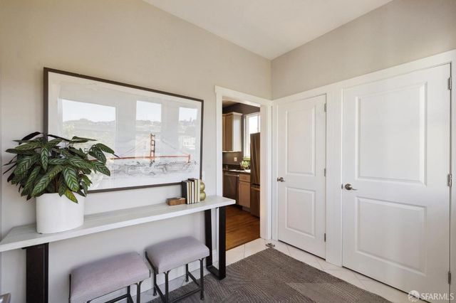 a living room with furniture and potted plant