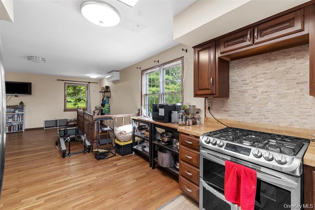 332 Springtown Road New Paltz, NY 12561 - Photo 14 of 19 a kitchen with a stove a sink and a wooden cabinets