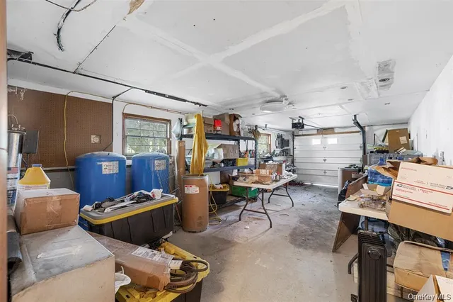 a living room with lots of furniture and view of kitchen