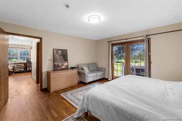 a bedroom with a large bed and a wooden floor