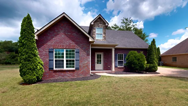 a front view of a house with a yard