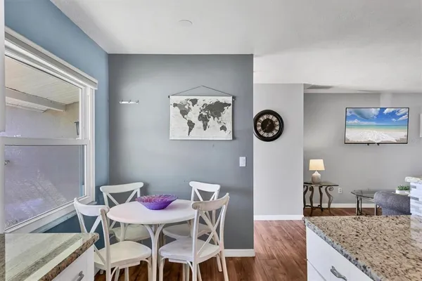 a view of a dining room with furniture and wooden floor