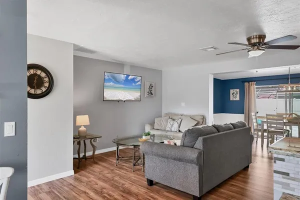 a living room with furniture wooden floor and a window